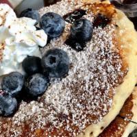 Blueberry Pancakes · 3 delicious blueberry stuffed buttermilk pancakes with powdered sugar and blueberries on top...