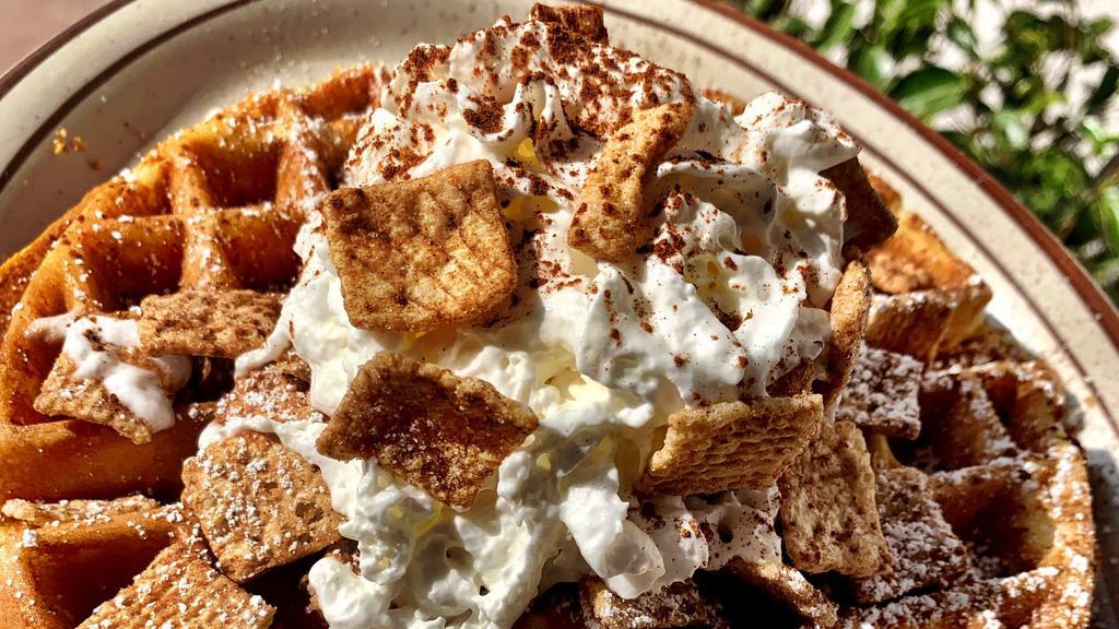 Cinnamon Toast Crunch Waffle · Cereal infused crispy waffle topped with cinnamon, bananas and... even more cereal. Topped with powdered sugar with whipped cream & syrup on the side.