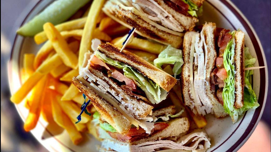 Turkey Club Sandwich · Turkey breast, bacon, lettuce, tomato & cheese on choice of bread. Served with choice of side.