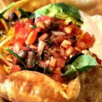Taco Salad · Crispy taco shell filled with mixed greens, ground beef, cheddar cheese, tomato, avocado, so...