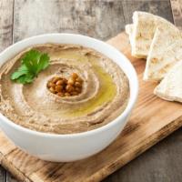 Hummus · Fresh garbanzo beans blended with fresh garlic, lemon juice, and tahini drizzled with extra ...