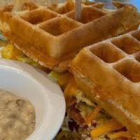 Breakfast Waffle Sandwich · 2 eggs your way, cheddar cheese and your choice of bacon or sausage. Served with country gra...