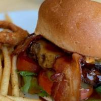 Outlaw Burger · 1⁄2 lb Angus beef patty with bacon, cheddar cheese, beer battered onion rings, BBQ sauce, le...