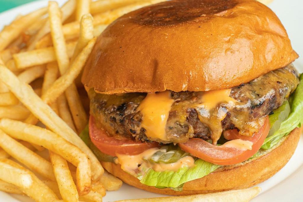 All-American Burger · A 1⁄2 lb beef patty with lettuce, tomato, onion, pickles, cheddar cheese and thousand island dressing on a brioche bun.