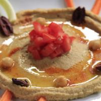 Hummus · Garbanzo tahini puree, spiced up with roasted peppers and Mediterranean spices.