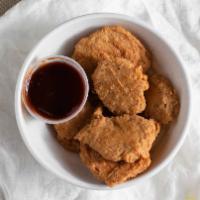 Chicken Nuggets · 6 pieces. Crispy chicken nuggets served with BBQ sauce.