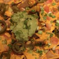 Nacho Supreme · Organic corn tortilla, guacamole, jalapeno, tomato, scallion and homemade nacho cheese.