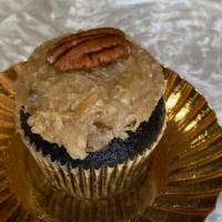 German Chocolate · Chocolate Cake, filled with coconut, pecan pieces,
and topped with a half Pecan.