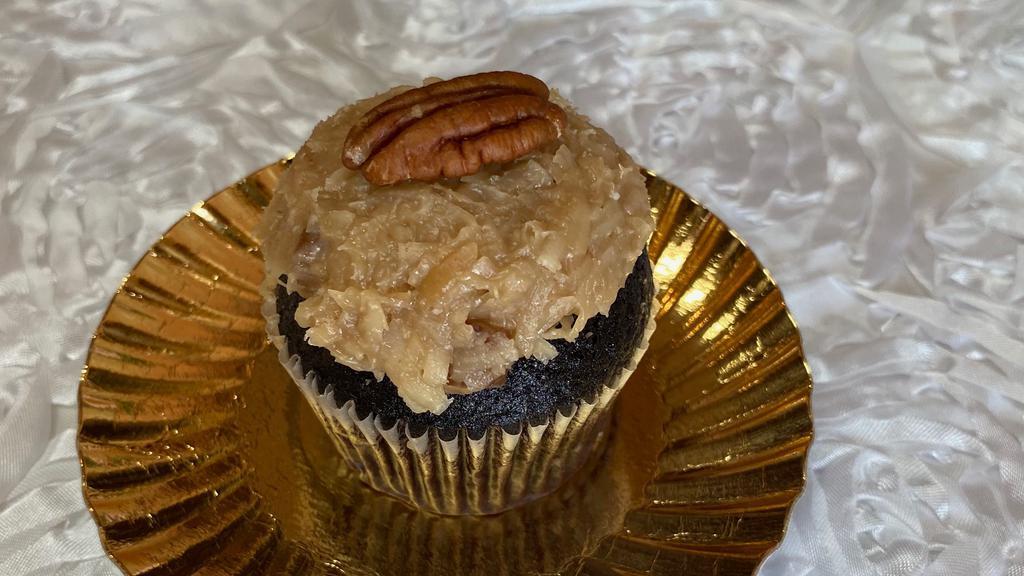 German Chocolate · Chocolate Cake, filled with coconut, pecan pieces,
and topped with a half Pecan.