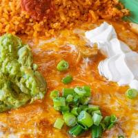 Enchiladas Rancheras · Two enchiladas stuffed with cheese, shredded beef or chicken. Topped with ranchera sauce, ch...
