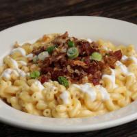 The Loaded Beast · Traditional mac & cheese, bacon, green onions, crème fraîche, fried shallots & roasted garli...