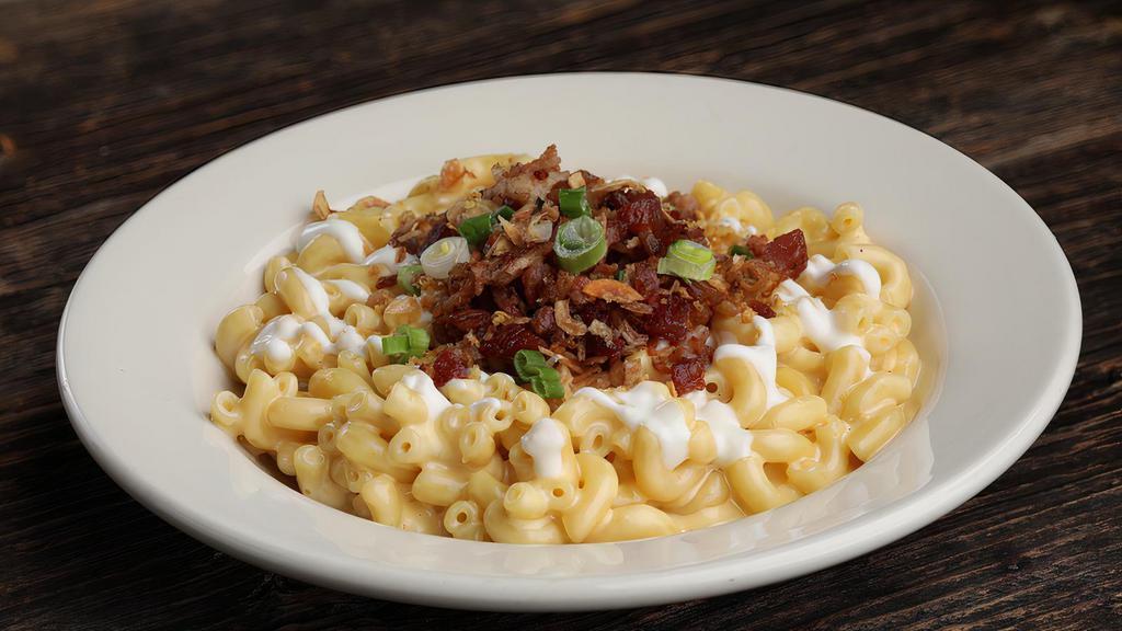 The Loaded Beast · Traditional mac & cheese, bacon, green onions, crème fraîche, fried shallots & roasted garlic chips