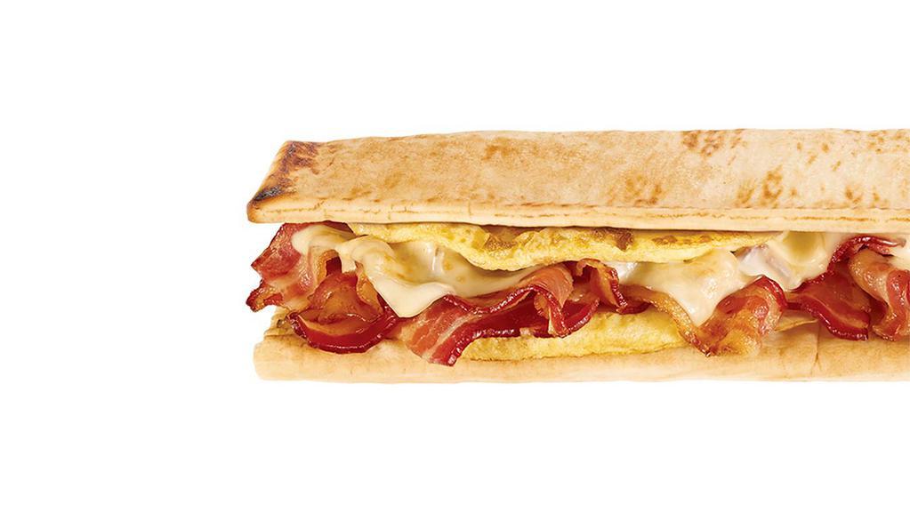 Bacon, Egg & Cheese Footlong · Start your day in a sizzlin' way with crispy bacon, egg and melty cheese on freshly toasted flatbread or whatever you like. It's hard to imagine this trio of tasty ingredients could get even better, but just wait till you try it with everything from juicy tomatoes to green peppers for a full on flavor free-for-all.