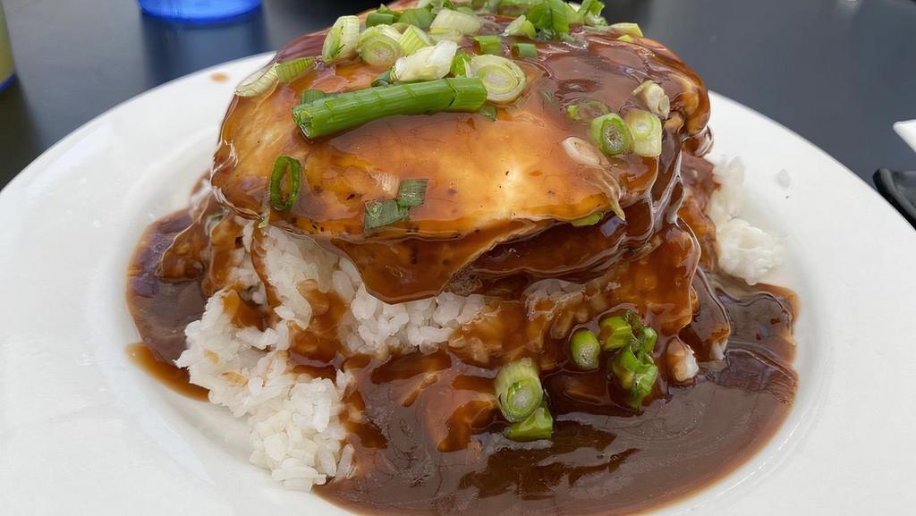 Loco Moco · Hawaiian dish. Grilled seasoned beef patty covered with a rich gravy & topped with one over easy egg.