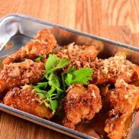 Chicken Wings · Crispy wings glazed with tamarind sauce and fried onion.