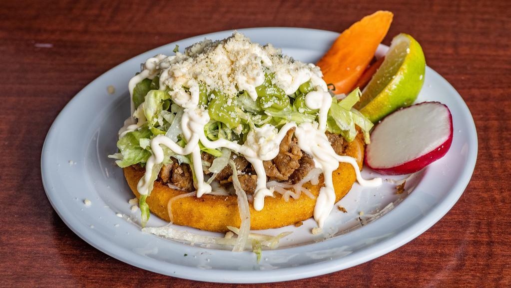 Sopes · Cheese, Choice of meat, Onions, Cilantro, Salsa (mild or hot), Sour Cream, & Lettuce