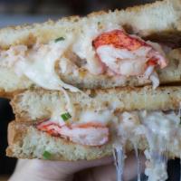 Clobster Grilled Cheese · Melting mix of lobster, crab, & a creamy herb sauce. Comes with one side of awesome sauce too.