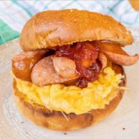 Loaded Sausage Breakfast Sandwich · Fried eggs, sausage, tomato, and cheese on your choice of bread.