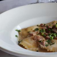 Lobster Ravioli · Light cream garlic sauce with prosciutto and green peas.