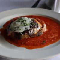 Melenzane Magnifico · Eggplant layered with mozzarella and ricotta cheese with a tangy tomato sauce.