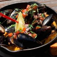 Steamed Mussels · Simmered in a cast iron skillet with white wine, fresh lime, tequila, tomato, garlic butter,...