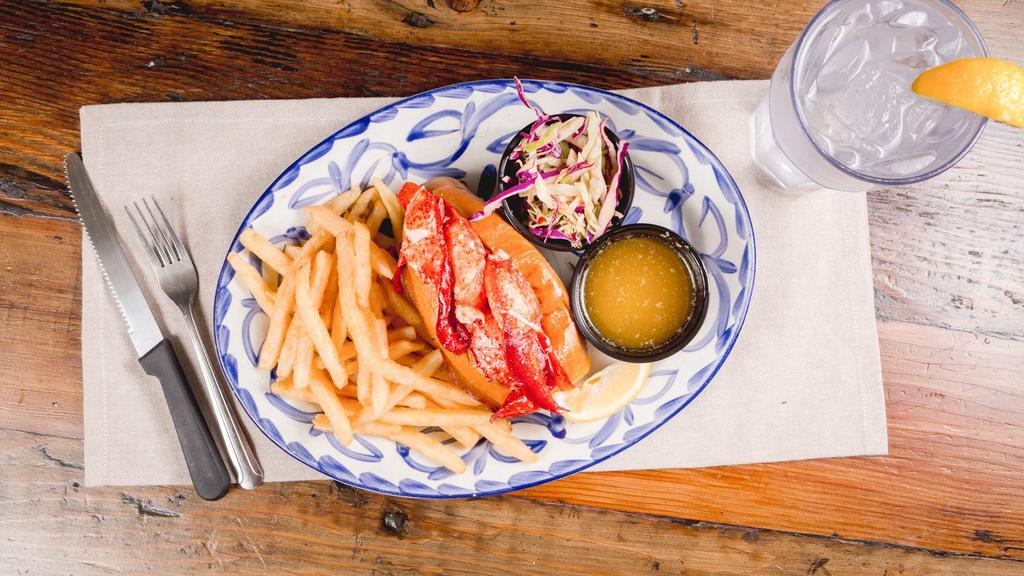 Warm Lobster Roll · Maine lobster meat poached in butter and stuffed in a grilled new England style roll served with a side of spicy slaw and warm butter.