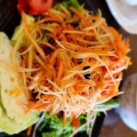 Papaya Salad · Spicy. Shredded raw papaya, carrots with tomatoes, peanuts, and chili in spicy lime dressing.