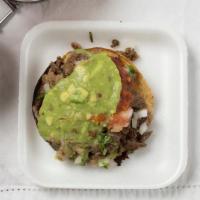 Tostadas · dehydrated corn tortilla with choice of meat and ad ons.