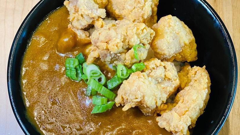 Chicken Karaage Curry · Chicken Karaage over rice with Japanese style curry, topped with green onions.
