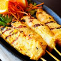 Chicken Satay · Marinated and grilled skewer served with peanut sauce and cucumber salad.