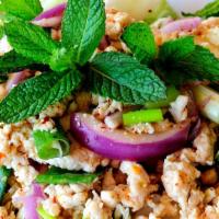 Chicken Larb · Ground meat mixed with toasted rice and lettuce in spicy lime dressing.