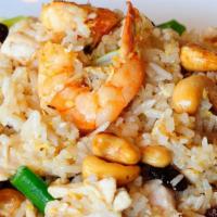 Pineapple Fried Rice · Stir fried rice with shrimp, chicken, pineapple chunks, raisins, cashew nut, egg, and yellow...