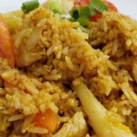 Yellow Curry Fried Rice · With peas, carrots, egg, tomatoes, green onion, and yellow curry powder.