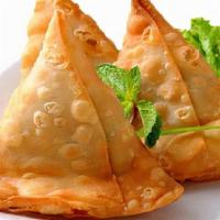 Vegetable Samosa · Deep-fried crisp turnover filled with mildly spiced potatoes and peas