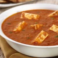 Paneer Tikka Masala · Homemade cheese cubes cooked in a creamy butter sauce with fresh tomatoes.