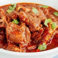 Lamb Vindaloo · Hot and spicy lamb cooked with pieces of potatoes fresh tomato and a touch of fresh lemon ju...