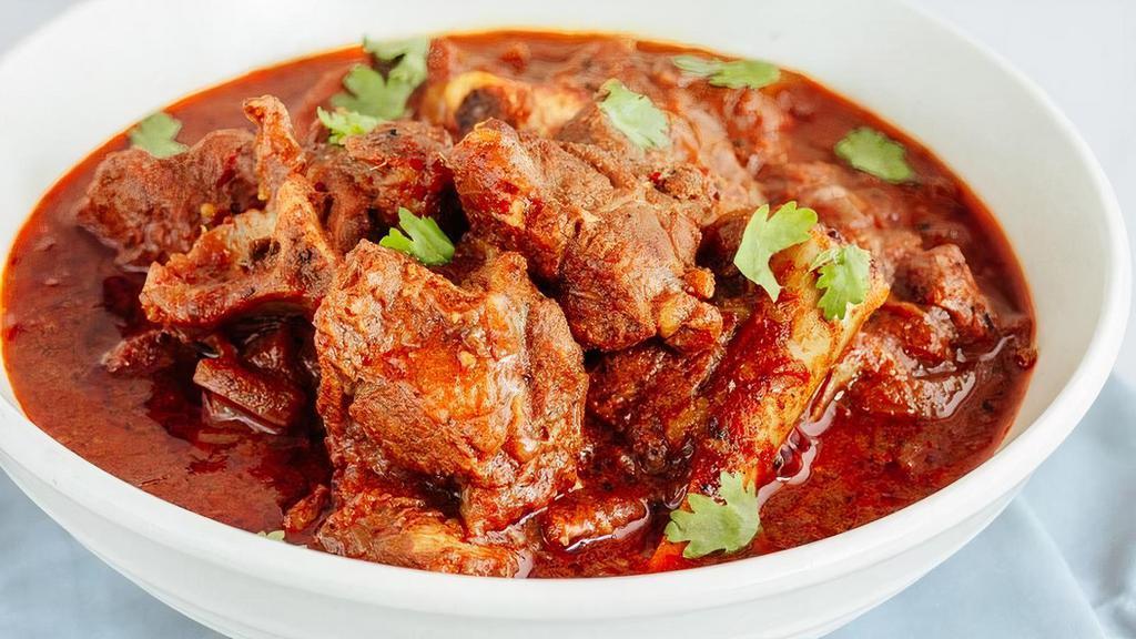 Lamb Vindaloo · Hot and spicy lamb cooked with pieces of potatoes fresh tomato and a touch of fresh lemon juice.