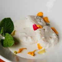 Ras Malai · Soft poached house-made cheese dumplings, in a reduced milk sauce, garnished with nuts.