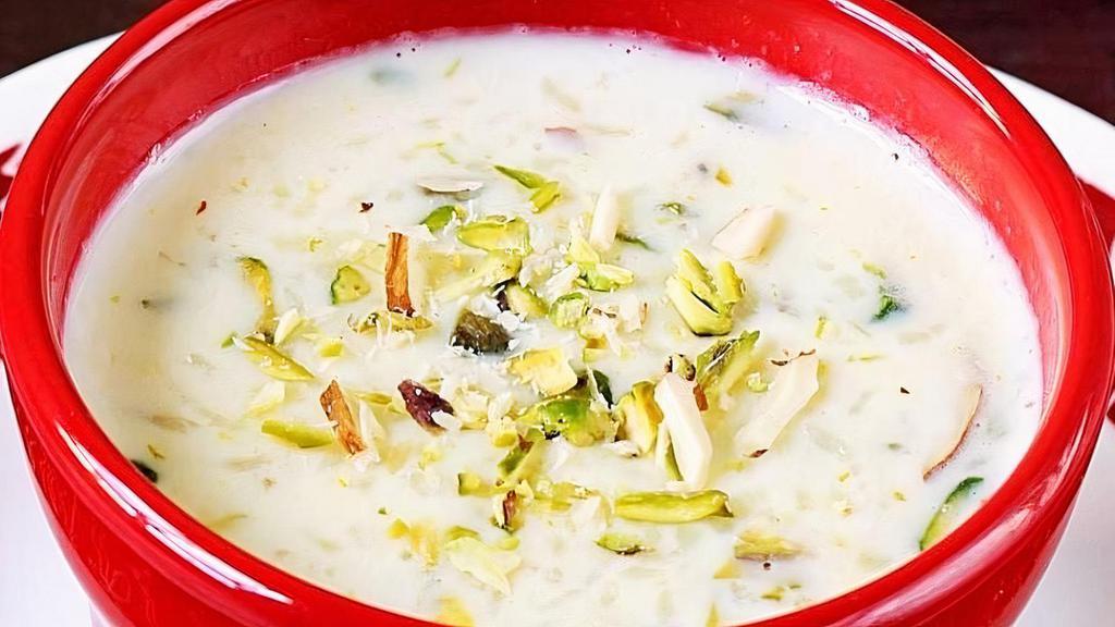 Elaichi Kheer · Creamy rice dessert, delicately flavored with cardamom, garnished with pistachio.