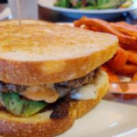 Auburn Burger · Cheddar, bacon, avocado, grilled onions, thousand island, on grilled sourdough bread.