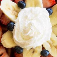 Deluxe Waffle · Topped with fresh fruit and whipped cream.