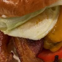 Fried Egg Burger · Angus beef patty topped with American cheese, bacon, fried egg, lettuce, tomato, onion, pick...