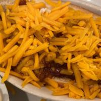 Chili Cheese Dog · Topped With three-bean beef chili, chopped onion and sharp cheddar cheese.