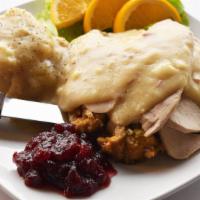 Roasted Turkey Dinner · Tender slices of our freshly roasted turkey breast over homemade stuffing and smothered with...