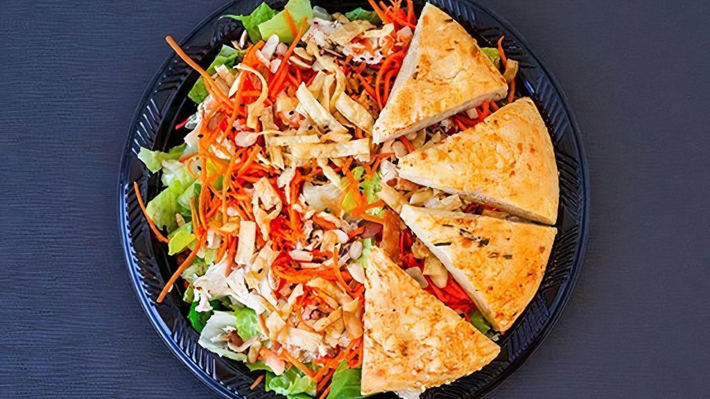 Asian Chicken Salad · Romaine lettuce, grilled chicken breast, carrots, sesame seeds, wonton strips, toasted almonds, and low-fat Asian dressing.