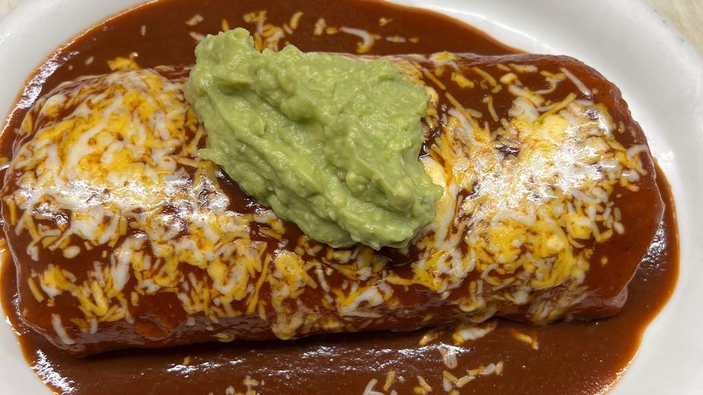 Super Burrito Deluxe Ground Beef · Ground beef, beans, rice and lettuce, wrapped in flour tortilla, smothered in sauce, melted cheese, topped with guacamole.