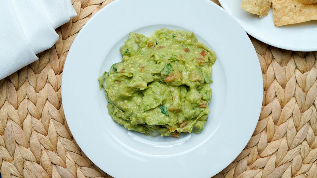 Guacamole Dip · Freshly smashed avocado, diced tomatoes, cilantro and onions served with crispy tortilla shell.