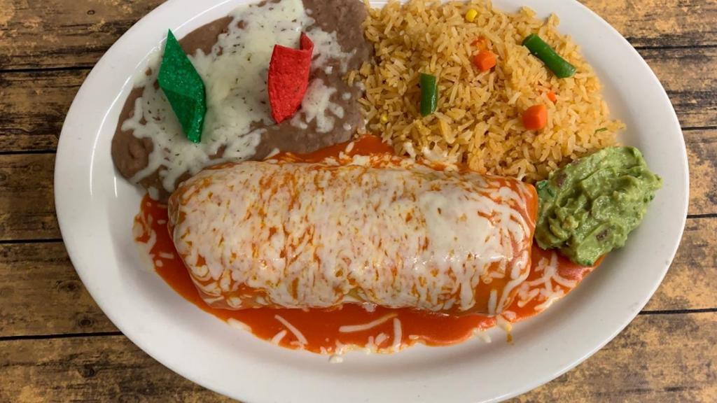 Carne Asada Burrito · Marinated steak, shredded cheese, and refried beans topped with red sauce and melted cheese. Served with a side of guacamole.