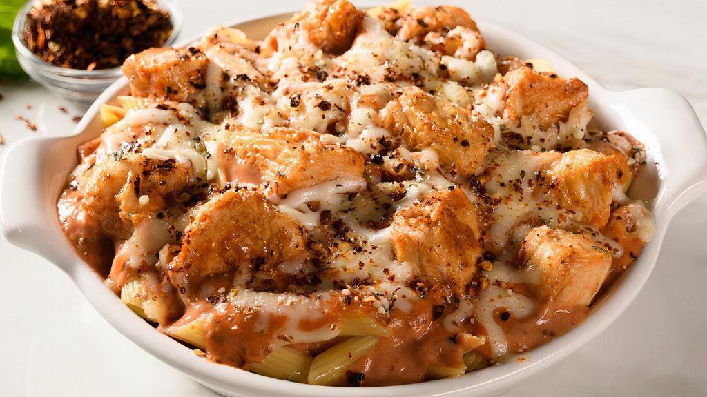 Spicy Baked Ziti With Chicken · Penne pasta topped with spicy tomato pepper sauce, chicken, and baked with mozzarella and provolone cheese. Includes 2 of our Signature Garlic Breadsticks
