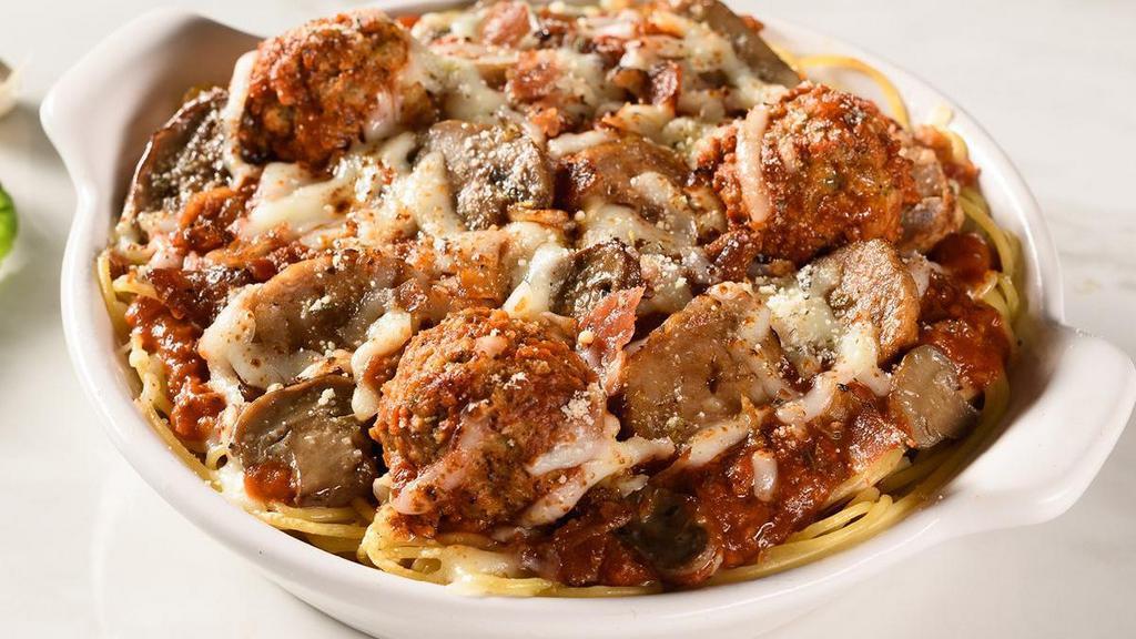 Loaded Baked Spaghetti · Spaghetti topped with meat sauce, meatballs, mushrooms, Italian sausage, and bacon.  Baked with mozzarella and provolone cheeses.. Includes 2 of our Signature Garlic Breadsticks.  . If you're looking to add an additional side or toppings, please visit the Sides/Extras section of the menu.